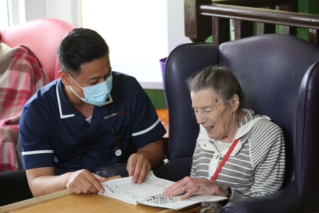 care worker reading with resident